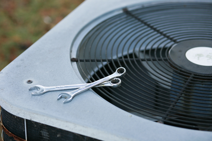 ac-repair-wrenches-on-outdoor-ac-unit